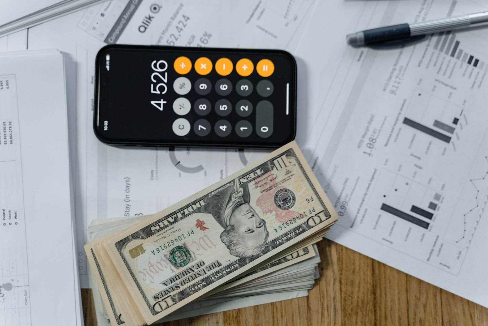 Calculator and financial paperwork used to verify credit report figures before filing a dispute