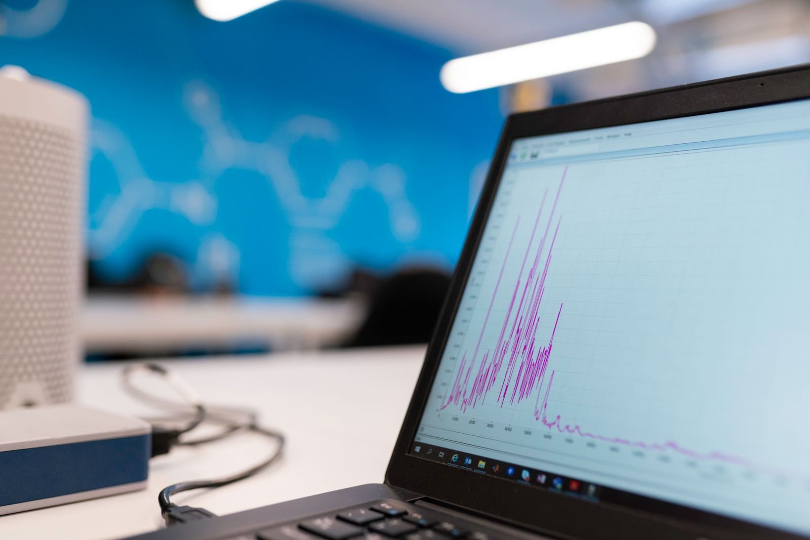 Laptop screen showing a credit score graph trending upward after a successful dispute